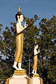 Vientiane, Laos - Pha That Luang, the elegant structure, Wat That Luang Neua, with a very ornate front faade fronted by two tall standing Buddha statues. 